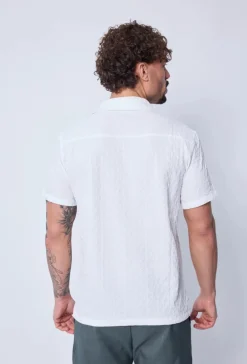 Chemise unie manches courtes à motifs géométriques