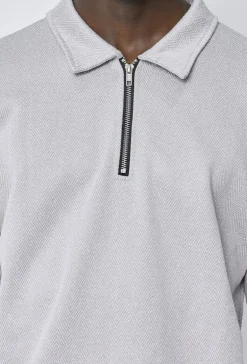 Polo couleur uni manche longue à zip