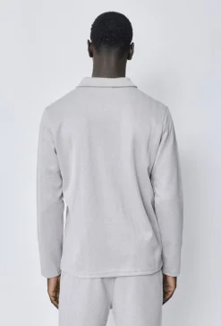 Polo couleur uni manche longue à zip